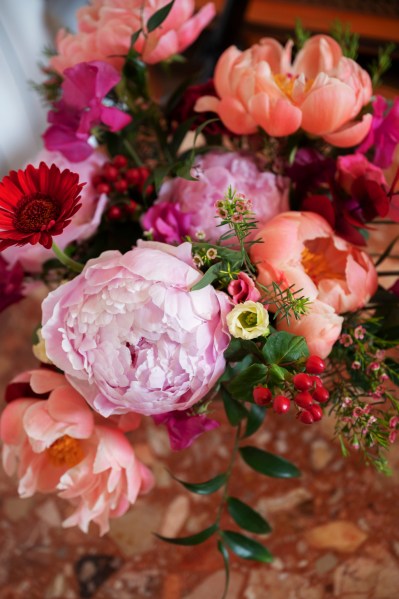 Flowers placed beside window frame candles lighting